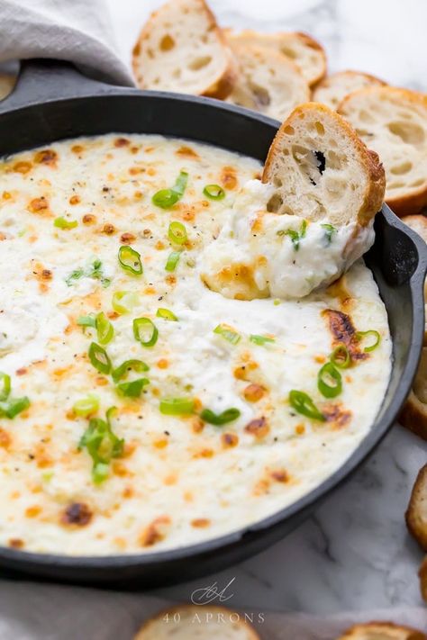 This crab dip is truly addictive! It's a super easy and ultra delicious, rich and creamy appetizer made with crab, green onions, cream cheese, mayo, and cheese. Served with crackers, chips, or bread for the best tailgating, holiday, or party dish. Low carb, keto, gluten free. #appetizer #dip #tailgating #entertaining #keto Baked Crab Dip, Creamy Crab Dip, Ricotta Dip, 40 Aprons, Baked Ricotta, Keto Gluten Free, Hot Crab Dip, Creamy Crab, Gluten Free Appetizers