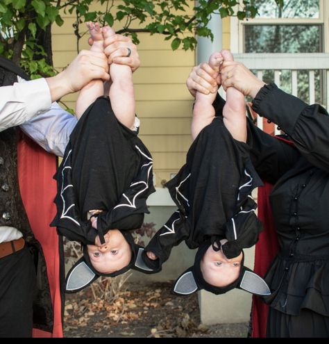 Two babies in bath costumes held upside down Bat And Vampire Family Costume, Vampire And Bat Family Costume, Family Halloween Costumes With Twins, Family Bat Costume, Twin Halloween Costumes For Babies, Twin Baby Halloween Costumes, Baby Twin Halloween Costumes, Twins Halloween Costumes, Bats For Halloween