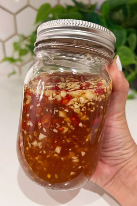 Impress your taste buds with Vietnamese Fish Sauce showcased in a glass mason jar which includes fresh garlic and Thai chili peppers. Egg Roll Sauce, Fish Dipping Sauce, Fish Sauce Recipe, Vietnamese Sauce, Vietnamese Fish Sauce, Picky Bits, Vietnamese Egg Rolls, Vietnamese Salad, Vietnamese Fish