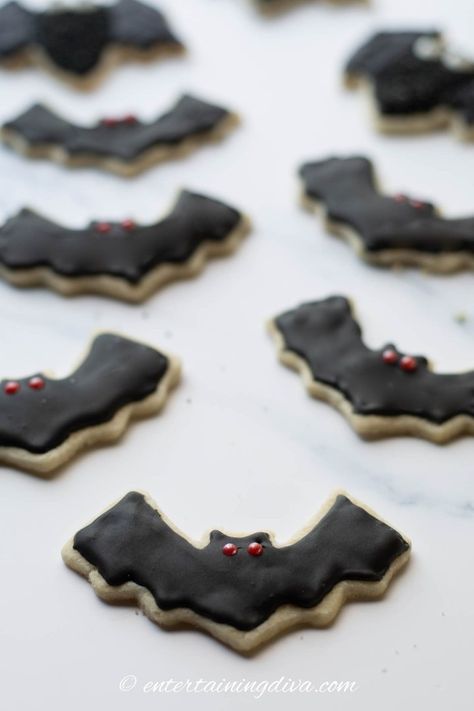 These adorable Halloween bat sugar cookies are so cute and easy to make! They're the perfect Halloween treat for a party! | Halloween Bat Sugar Cookies, Black Royal Icing, Sugar Cookies Halloween, Halloween Bat Cookies, Bat Cookies, Pearl Eyes, Halloween Sugar Cookies Decorated, Bats Cookies, Recipes Halloween