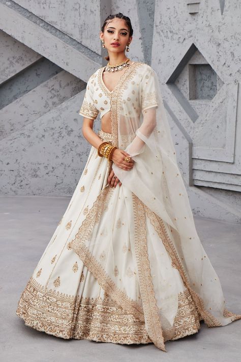 White lehenga with gold dori, aari and sequin embroidery. Comes with blouse and organza dupatta. Component: 3 Pattern: Embroidery Type Of Work: Sequin, Dori and Aari Neckline: V neck Sleeve Type: Half Fabric: Chanderi and Organza; Lining: Shantoon Color: White Other Details: Dupatta with embroidered cutwork border Blouse with curved hem Cutwork detail waistband Note: Only selling the product mentioned in the description from the video. Occasion: Wedding - Aza Fashions Double Dupatta Lehenga, Pastel Bridal Lehenga, Double Dupatta, Ivory Lehenga, Pastel Lehenga, White Lehenga, Raw Silk Lehenga, Anamika Khanna, Karisma Kapoor