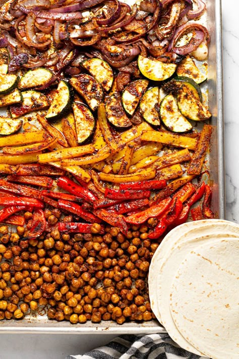 These quick and easy vegan Sheet Pan Chickpea Fajitas are a delicious weeknight dinner that comes together in under 30 minutes. Loaded with chickpeas, peppers, onions, and zucchini along with a signature fajita seasoning - this simple dinner will quickly become a family favorite. Chickpea Fajitas, Healthy Sheet Pan Dinners, Vegetarian Fajitas, Vegan Fajitas, Healthy Sheet Pan, One Pan Dinner Recipes, Vegetarian Stuffed Peppers, Dinners To Make, Pan Dinners