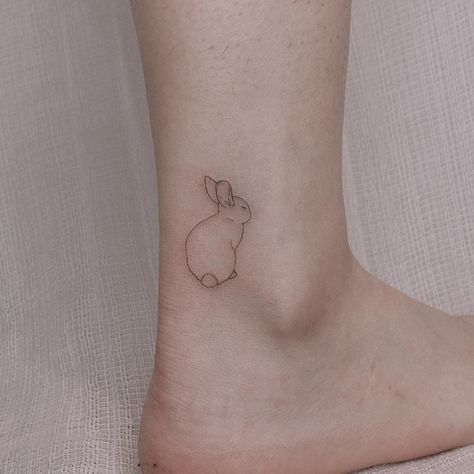 Bunny on ankle tattoo Love Bunny Tattoo, Single Line Bunny Tattoo, Minimalistic Bunny Tattoo, Bunny Nose Tattoo, Pet Rabbit Tattoo, Leaping Bunny Tattoo, Cute Bunny Tattoos, Bunny Ear Tattoo, Simple Rabbit Tattoo