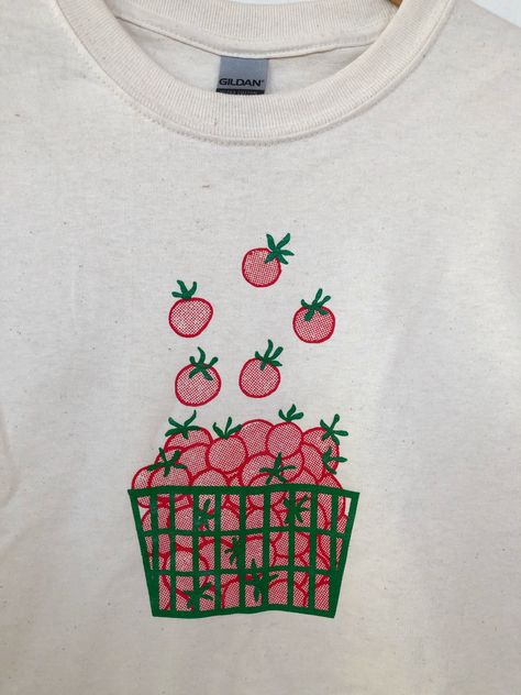 "Hand Printed and Hand Drawn! This is a 100% cotton screen printed t shirt with a hand drawn basket of tomatoes. It's perfect for summer! The shirts shown here are natural and are printed in red and green ink. // PROCESS: All of our items are individually hand printed by either me or my dad, which can lead to slight variations in placement. The ink is heat cured and will not fade over time. Since our items are printed to order, there is a 1-2 week processing time before shipping. If you absolute Classic T Shirt Design, Printing Shirt, Vintage T-shirt With Screen Print, Screen Printed Shirt, Graphic Tee Cotton T-shirt With Screen Print, Printed Tshirts, Graphic Design Tee Shirt, Screenprinted Shirt, Cotton Graphic Tee With Screen Print