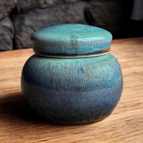 This is a beautiful keepsake mini sized urn.   I have made this extra small urn on my potters wheel using soft porcelain clay.   The approximate capacity is 5 cubic inches. (equal to about 5 lbs. before cremation) or 1/4 -1/3 cup.  Overall dimensions are 2.5" tall x 2.5" wide.  Please feel free to message me with any questions -Extra helpful information - 1.) This glaze surface is a Glossy and Shiny surface. 2.) All of my pieces are one of a kind and handmade.   3.) Your order comes with easy to follow instructions for permanent sealing.   4.) If you need expedited or overnight shipping don't hesitate to message, we can do it.   5.) If your overseas please message so I can provide accurate shipping costs. 6.) I'm happy to help with additional information, images or anything you may need to Small Urns, Keepsake Urns, Porcelain Clay, Potters Wheel, We Can Do It, Im Happy, Cemetery, Glaze, Porcelain