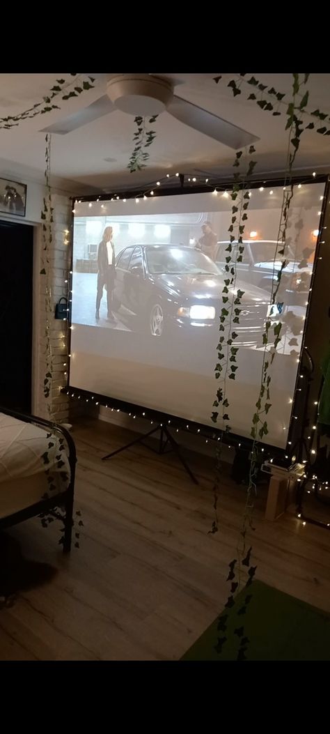 Projector, fairy lights, ivy vines, converted garage Projector Screen Room Ideas, Projector In Garage, Fairy Lights And Vines Bedroom, Projector In Bedroom, Christmas Projector, Converted Garage, Diy Room Decor For Teens, Fairy Lights Bedroom, Projector Screen