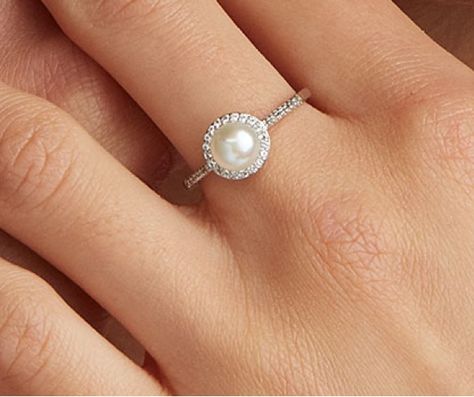 Love the look of a pearl but not sure if it’s the right choice for you? Here’s what you need to know about the pros and cons of a pearl engagement ring. Engagement Ring With Pearls And Diamonds, Pearl Halo Engagement Ring, Ring Daily Wear, Engagement Ring Minimalist, Pearl Wedding Ring, Dainty Jewellery, Pearl Engagement Ring, Ring Pearl, Future Engagement Rings