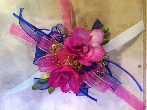 Wrist corsage made with fragrant freesia and accented in hot pink/fuschia, gold, and navy. Blue And Pink Corsage, Corsage For Hot Pink Prom Dress, Corsage Prom Hot Pink, Hot Pink Flower Corsage, Hot Pink And Black Corsage Prom, Wristlet Corsage, Blue Corsage, Wrist Corsage Prom, Corsage Prom