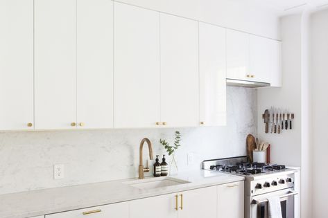 The kitchen is a modified Ikea system with Ringhult glossy white cabinet doors and brass hardware from Rejuvenation. Ikea Ringhult, White Kitchen Cabinet Doors, White Ikea Kitchen, Glossy Kitchen, Ikea Hack Kitchen, Ikea Kitchen Cabinets, Ikea Cabinets, White Kitchen Design, Custom Kitchens