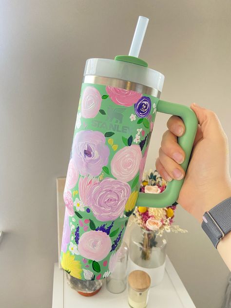 Mystery Stanley! Are you looking for the perfect thing to add to your Stanley collection? Or do you need the perfect gift idea?  I will paint you an authentic Stanley Tumbler with a unique floral design! The color of your Stanley and the color of the flowers will be a surprise: the best kind of gift to unwrap! Each one is hand painted and completely unique!  Once painted, the Stanley is sealed to be scratch and water resistant. To preserve your design the best, I recommend washing by hand in lukewarm or cool water.  Already have a Stanley you would like painted? Head to my shop to order a custom design painted on your tumbler! Hand Painted Tumblers, Painted Stanley Cup, Stanley Collection, Painted Tumblers, Cup Toppers, Tumblers Epoxy, Girls Night Crafts, Unique Floral Design, Custom Stanley