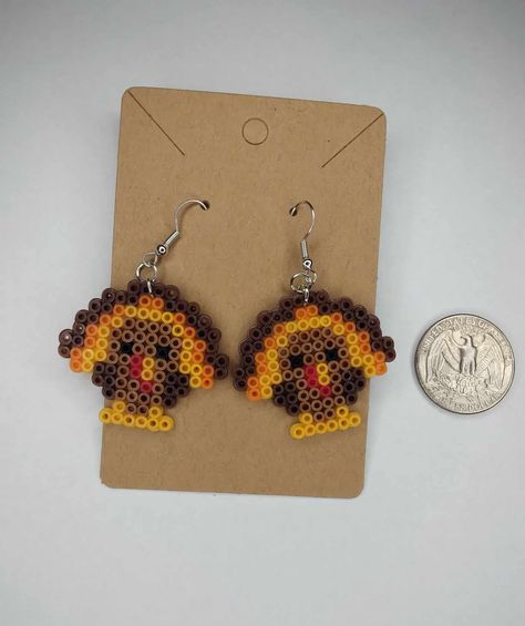 handmade pixel bead items Diy Perler Bead Jewelry, Perler Bead Christmas Earrings, Pearled Bead Earrings, Pixel Art Thanksgiving, Perler Bead Patterns Thanksgiving, Thanksgiving Beaded Crafts, Perler Beads Earrings Ideas, Turkey Perler Bead Patterns, Acorn Perler Bead Patterns