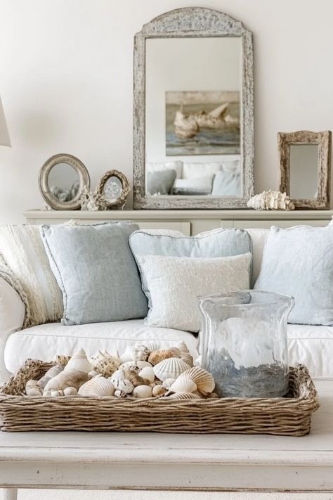 Artful blend of coastal and vintage styles showcased through beautiful home decor ideas. This pin highlights stylish coastal vintage designs to elevate your living space, using 1 image. French Costal Interior, Coastal Side Table Decor, Neutral Coastal Aesthetic, French Beach House Decor, French Country Coastal Decorating, French Country Coastal, Neutral Coastal Living Room, Vintage Beach House Decor, French Coastal Decor