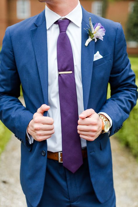 Suit: Mens Wearhouse  Tie: Mens Wearhouse  Belt: Mens Wearhouse Watch: Zumiez Florals: Gabriela Creations  #groom #groomsuit #weddingsuit #navyand purple wedding #bluesuits #wedding #weddingday #rainydaywedding #groomsmen Blue And Purple Groom Suit, Blue And Purple Outfit Men, Blue And Purple Suit Men, Navy Suit With Purple Tie, Purple And Blue Suit, Navy Blue Suit Purple Tie, Blue Suit Purple Tie Wedding, Blue And Purple Tuxedo Wedding, Tangled Wedding Groom