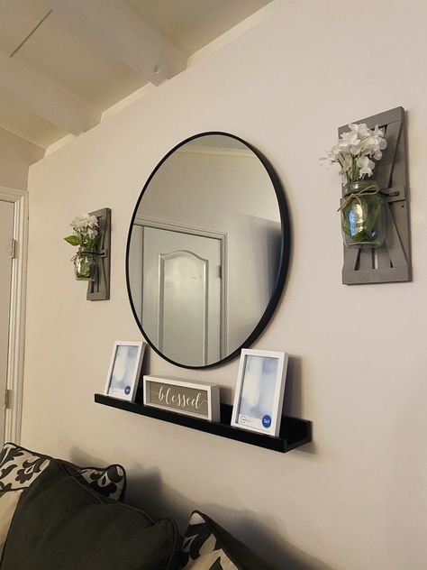 Large Circle Mirror Living Rooms, Bedroom Wall Decor With Mirror, Circle Mirror Wall Decor Living Room, Living Room Circle Mirror, Wall With Circle Mirror Decor, Decorating Around Mirror On Wall, Wall Decor With Circle Mirror, Mirror And Shelf Wall Decor Living Room, Circle Mirror Living Room Decor