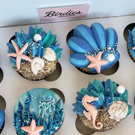 Macy Schmelzer on Instagram: "An underwater + sea creature theme for a baby shower 🌊🐚🪼I absolutely loved coming up with the designs for these! Definitely check out my story or “Inspiration!” highlight on Instagram to see the reference I was sent for this set 🫧   #babyshowercupcakes #oceancupcakes #seacreaturecupcakes #beachcupcakes #oceanbabyshower #beachbabyshower #wiltoncakes #birdiescupcakes" Sea Creature Cupcakes, Sea Themed Cupcakes, Ocean Desserts, Mermaid Birthday Cupcakes, Underwater Party Theme, Shell Cupcakes, Under The Sea Cupcakes, Sea Baby Shower Theme, Ocean Cupcakes