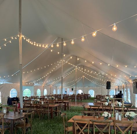 The cafe string lights can transform a tent into a beautiful welcoming space with just the right amount of warmth and elegance. #tents #stringlights #weddings #tentrentals #partytents #2025weddings #outdoorevents #weddingtents #partyrentals Wedding Tent Ceiling Decor, Rustic Tent Wedding, Pole Tent Wedding, Tent Wedding Decor, Tent With Lights, Diy Wedding Tent, Tent For Wedding, Wedding Tent Lighting, Wedding Tent Decor