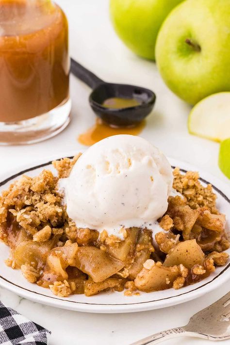 a bowl of Apple Crisp topped with a scoop of ice cream and caramel sauce in the background. Vegan Apple Crumble, Oatmeal Crumble Topping, Apple Crisp With Oatmeal, Dutch Apple Pie Recipe, Easy Apple Crisp, Traditional Apple Pie, Caramel Apple Dump Cake, Apple Crumble Recipe, The Food Charlatan