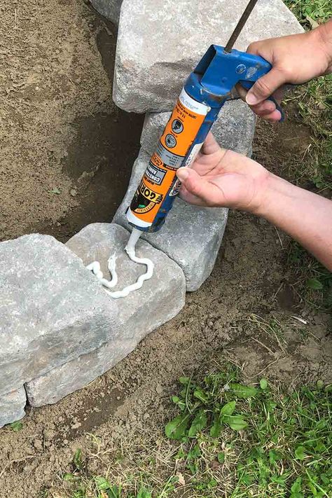 Applying adhesive to the stone Diy Stone Fire Pit, Diy Fire Pit Area, Paver Fire Pit, Make A Fire Pit, Backyard Homestead, Outdoor Fire Pit Area, Easy Fire Pit, Brick Fire Pit, Fire Pit Ring