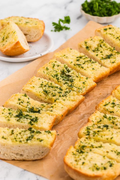 This garlic bread recipe is simple and easy, and yields the BEST garlic bread! Minced fresh garlic is sautéed with olive oil to mellow it out, then mixed with soft butter, salt, and fresh herbs and smeared over a fresh loaf of French bread then baked until melted inside and crispy outside. Garlic herb bread is perfect as a side for soups, pasta, and so much more! Homemade Garlic French Bread, Garlic Bread With Olive Oil, Whole Wheat Garlic Bread, Crunchy Garlic Bread, English Muffin Garlic Bread, Garlic Bread With French Bread, Bread Garlic Toast, Diy Garlic Bread, French Bread Garlic Bread