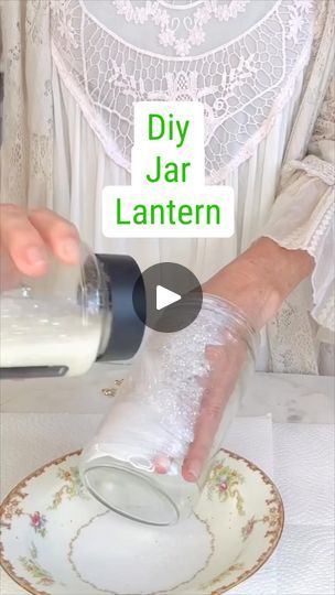 1K views · 18 reactions | DIY Jar Lantern ✨ | Transforming an ordinary jar into a charming upcycled lantern—perfect for adding a touch of warmth to any space!✨ | By Olivia's Romantic Home DIY | Let's upcycle this salsa jar
and create a beautiful Christmas lantern idea. Okay so
I had this salsa jar cleaned it out really well and then taking
a layer of Mod Podge. I'm adding that Mod Podge to the
exterior of my container and then adding some of this
glitter that I found at Walmart. They come in huge
packages. You guys can really get glitterfit this Christmas.
I dug into my craft stash. I had this pretty golden
sparkling ribbon from last season and then just add a some
bits and bobs with some greenery and you guys could get
so creative with this part and really make it shine. Make it
fit your Glitter Jars Diy How To Make, Salsa Jar Crafts, Upcycled Lantern, Salsa Jar, Christmas Lantern Ideas, Fairy Lights In A Jar, Diy Jar, Lantern Ideas, Romantic Home