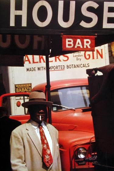 SAUL LEITER :: Harlem, 1960 I like the use of red in this image and concentration of signs behind the man. The signage makes great framing for the photo. London Gin, William Klein, Saul Leiter, William Eggleston, Diane Arbus, Robert Frank, Mario Sorrenti, New York School, Paolo Roversi