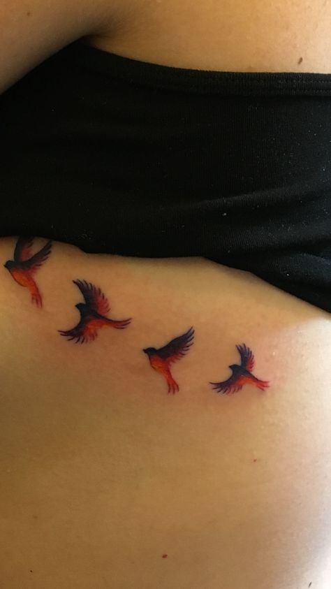 Birds flying into the sunset ribcage tattoo Cardinals Flying Tattoo, Bird Ribcage Tattoo, Bird Tattoo Ribcage, Cardinal Flying Tattoo, Flying Cardinal Tattoo, Cardinals Tattoo, Winter Tattoos, Red Bird Tattoo, Cardinal Bird Tattoos