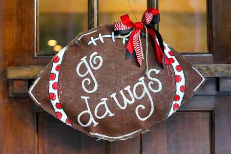 How to make your own DIY Hanging Burlap Football. Quick and easy instructions! Georgia Bulldog burlap door decor wreath. Burlap Door Hangers Diy, Bulldog Crafts, Door Hanger Tutorial, Burlap Door Decorations, Burlap Door Hangings, Front Door Baskets, Football Door Hangers, Burlap Door Hanger, Christmas Door Decoration