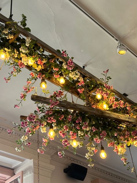 Floral Decor Restaurant, Ceiling Hanging Floral Decor, Hanging Faux Flowers From Ceiling, Ceiling Plant Decor, Flower Shop Lighting, Floral Restaurant Design, Moody Floral Decor, Faux Flower Ceiling, Neutral Massage Room