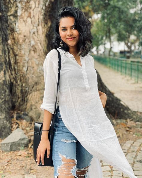 Prarthana Indrajith in a White Kurti White Short Kurti With Jeans, Prarthana Indrajith, Rajasthan Outfits, White Kurti, Kurti With Jeans, Smart Casual Women Outfits, Ripped Jeans Outfit, Smart Casual Women, Blue Jean Outfits