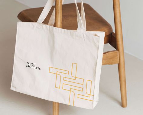 Logo and pattern design for an architecture studio on an eco bag. This design showcases the unique and modern style of the architecture studio, with clean lines and geometric patterns. The logo, prominently displayed on the bag, represents the studio's brand identity and creates a visual impact. The eco bag itself reflects the studio's commitment to sustainability and eco-friendly practices. #architecturestudio #logodesign #patterndesign #ecobag Architecture Bag, Eco Bag Design Ideas, Ecobag Design Ideas, Eco Bag Design, Company Identity, Corporate Image, Unique Branding, Architectural Prints, Eco Bag