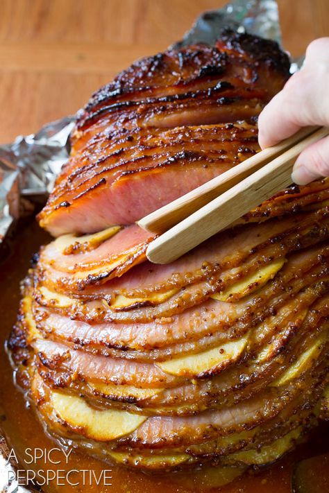 This Baked Ham Recipe is the perfect centerpiece to your holiday meal. Slathered with honey mustard ham glaze, stuffed with apples and baked to perfection! #ASpicyPerspective #Holiday # Easter #Christmas #Thanksgiving #Ham #BakedHam #BakedHamRecipe #HoneyMustard #Apples #HamGlaze Best Ham Recipe, Baked Ham Recipe, Easter Dinner Menus, Ham Recipes Baked, Honey Mustard Glaze, Easter Ham, Easter Menu, Ham Recipe, Baked Ham