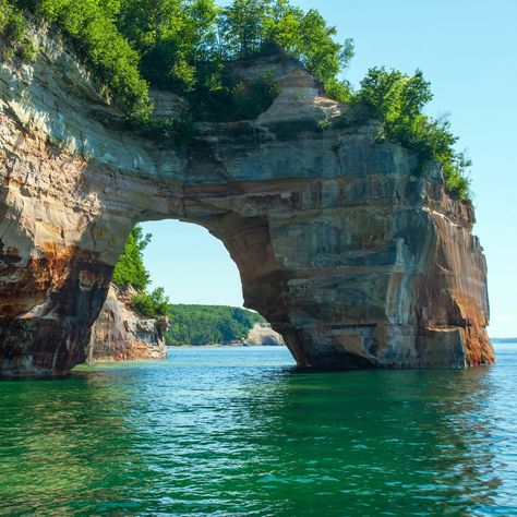 Pictured Rocks National Shoreline, situated between Munising and Grand Marais, is where you’ll find vibrant multi-colored limestone cliffs and waterfalls. Here are the things to know to visit the Pictured Rocks National Shoreline safely. Midwest Weekend Getaways, Pictured Rocks, Best Places To Vacation, Pictured Rocks National Lakeshore, Affordable Vacations, Best Weekend Getaways, Sea Kayaking, Beautiful Places To Visit, Go Camping