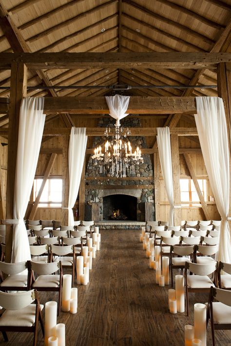 Panels of sheer, cream-colored fabric and elegant chandeliers were draped from exposed wood beams for an elegant touch to a rustic location Willow Branch Centerpiece, Barn Makeover, Shed Wedding, Wedding Drapery, Event Venue Spaces, Branch Centerpieces, Draping Wedding, Brides Dresses, Hall Ideas