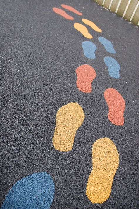 Footstep graphics within playground flooring can be a great way to help children learn to balance or line up.  #Play #Playground #PlayArea #PlaySurfacing #SafetySurfacing #Schools #Nursery #OutoorPlay #Footsteps Diriyah Gate, Architecture Roof, Sensory Path, Outside Flooring, Playground Surface, Flooring Texture, Playground Flooring, Playground Slide, Roof Windows