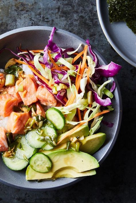 A tangy-sweet sushi-style rice with cubed salmon steamed on top. Serve with packaged coleslaw mix, sliced cucumbers, & avocado. Drizzle with vinaigrette of soy sauce, white vinegar, safflower oil, green onions, ginger & sesame oil. Can garnish with strips of nori or sprinkle with furikake. #Asian-style Sesame Salmon, Salmon Bowls, Leafy Salad, Salmon Bowl, Salmon And Rice, Nyt Cooking, Coleslaw Mix, Roasted Salmon, Sushi Rice