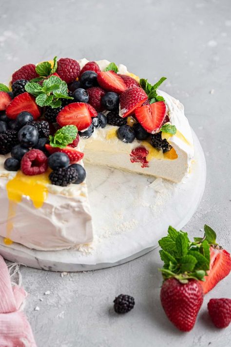 Berry Pavlova with Lemon Curd Cream: This classic pavlova recipe is the perfect entertaining dessert. Fancy enough for a dinner party, but extremely easy to make and everything can be made ahead of time! Pavlova Recipe Easy, Pavlova With Lemon Curd, Dessert Fancy, Classic Pavlova Recipe, Lemon Curd Cream, Berry Pavlova, Passover Feast, Entertaining Desserts, Pavlova Recipe