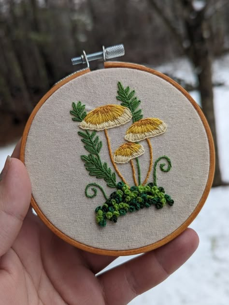 4 inch embroidery hoops with tricolor mushrooms and French knot moss Mushroom Embroidery Designs, Whimsical Embroidery Patterns, Embroidery Present Ideas, Embroidery Ideas Mushroom, Embroidery Patterns Mushrooms, Toadstool Embroidery, Embroidery Mushrooms Simple, Embroidery Designs Mushroom, Cottage Core Embroidery