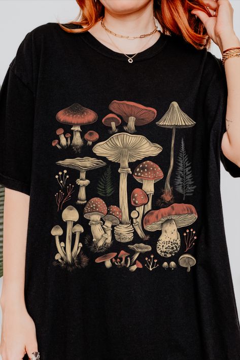 This Cottagecore Shirt embraces the beauty of mushrooms, perfect for any nature lover or garden enthusiast. Vintage Tee Shirt Designs, Mushroom Tshirt, Boho Mushroom, Aesthetic Mushroom, Mushroom T Shirt, Mushroom Shirt, Core Wardrobe, Vintage Tee Shirts, Casual Preppy Outfits