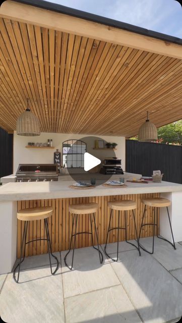 Esme | Garden Design & Landscaping on Instagram: "ALL WEATHER OUTDOOR KITCHEN 👨🏻‍🍳🍔🍕Our classic concrete x render kitchen but this time, it’s rain-ready!🌧️ Which means, outdoor BBQ’s & entertaining all year round (sub degree temperatures excluded)

We fitted out this incredible galley way kitchen for the Brookfield family with:
→ Two concrete counters; worktop & breakfast bar
→ @beefeaterbbq 7000 series 5 burner
→ @gozney pizza oven
→ @keburgarden larch wood pergola & cupboards
→ Ample storage space 
→ Integrated Bull fridge 
→ @sgweberuk chalk render walls

Drop us a message so we can build you your dream outdoor kitchen & entertainment space ✉️

#outdoorkitchen #outdoorliving #outdoorkitchendesign #gardendesign #landscaping" Outdoor Fireplace And Kitchen Ideas, Outdoor Kitchen Design Wood, Bbq Area Ideas Outdoor, Gozney Pizza Oven, Garden Kitchen Outdoor, Deck Kitchen, Concrete Counters, Concrete Outdoor Kitchen, Outdoor Kitchen Design Modern