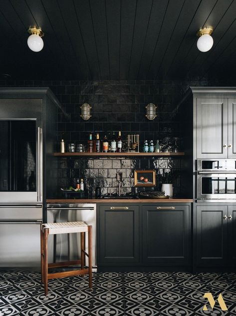 This moody and glamourous basement bar with Monogram appliances by Jean Stoffer at The Madison is impressive. Contractor: Kenowa Builders. Photographer: Stoffer Photography Interiors. Modern Basement Bar, Moody Kitchen, Bedrosians Tile, Modern Basement, Moody Interiors, Dark Kitchen, Dark Home, Classic Kitchen, Basement Bar