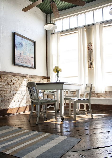 love the high windows and exposed brick chair rail. And the floors. Love everything about this. Brick Halfway Up Wall, Half Brick Accent Wall, Half Brick Half Panel Wall, Half Brick Interior Wall, Peekaboo Wall Between Kitchen And Dining Room, Exposed Brick Half Wall, Dining Room Half Painted Wall, Brick And Wainscotting Wall, Vertical Shiplap Half Wall Dining Room