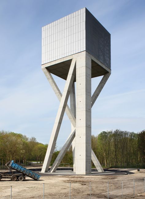 Belgian architecture studio V+ has completed a mesh-covered water tower that is supported by angled concrete columns Concrete Column, Lookout Tower, Concrete Architecture, Industrial Architecture, Tower Design, Architecture Awards, Brutalist Architecture, Rain Water Collection, Watch Tower