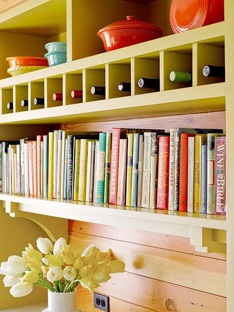 Oh, what to do with all those cookbooks? This bright bookshelf/storage wall solves that problem with style. Simple cubbies above the books store single bottles of wine, and colorful baking and serving dishes are displayed on the shelves above. Cookbook Display, Cookbook Storage, Decor Above Cabinets, Cookbook Shelf, Kitchen Furniture Storage, Inset Cabinets, Above Kitchen Cabinets, Above Cabinets, Best Kitchen Cabinets