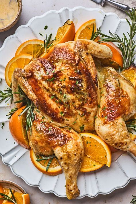 This Rosemary-Orange Spatchcock Chicken is coated with an orange zest butter, yielding a rich and decadent roasted bird full of citrus herby notes - a delicious winter citrus twist. Roasted spatchcock chicken easier to prepare that a whole roasted chicken and is your answer when you want a delicious, flavorful roast chicken cooked in under an hour. The delicious flavors of orange and rosemary make this a big family favorite dinner! Roasted Chicken Christmas Dinner, Christmas Roast Chicken, Spatchcock Cornish Hen Recipe, Chicken Thanksgiving Dinner, Orange Dishes, Roasted Spatchcock Chicken, Chicken Orange, Christmas Meals, Spatchcock Chicken