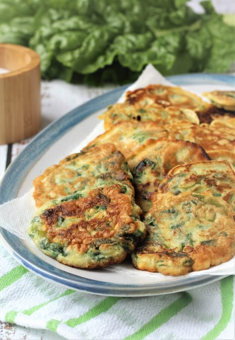 swiss chard frittelle rounds on an blue rimmed oval plate with chard leaves in background Chard Fritters, Mangia Bedda, Swiss Chard Recipes, Dinner Vegetarian, Cauliflower Fritters, Chard Recipes, Sicilian Recipes, White Bean Soup, Soup Dinner