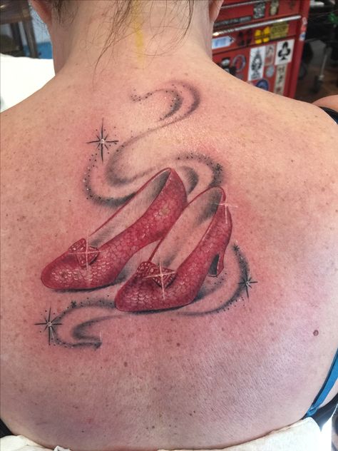 Ruby slippers Ruby Slippers Tattoo Wizard Of Oz, Ruby Red Slippers Tattoo, Ruby Slippers Tattoo, Disney Watercolour, Wizard Of Oz Tattoo, Strawberry Tattoos, Wrist Tats, Road Tattoo, Oz Tattoo