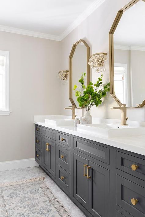 Glass droplets sconces flank a gold mirror over a black bath vanity accented with brass hardware and a brass faucet fixed above an overmount sink. Makeover Kamar Mandi, Vanity Ideas, Master Bath Remodel, Entrance Foyer, Foyer Design, Bathroom Remodel Shower, Lodge Decor, Upstairs Bathrooms, Bathroom Renos