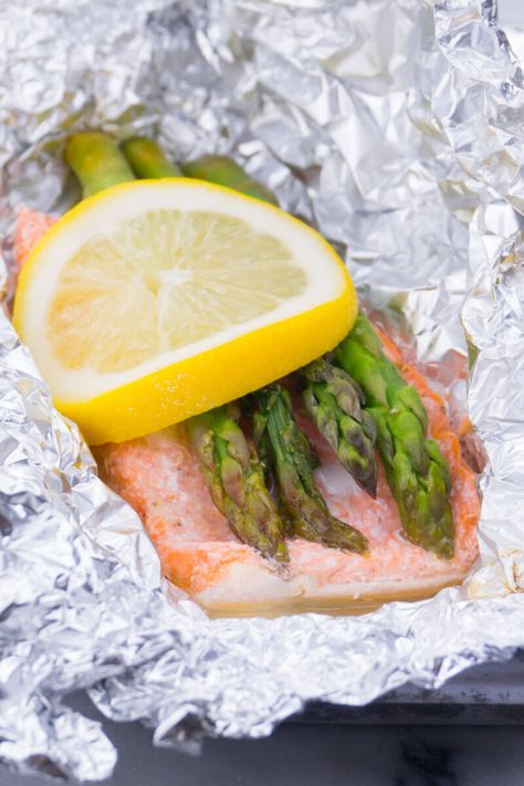 Baked Salmon Asparagus Foil Packet Recipe Salmon Asparagus Foil, Baked Salmon And Asparagus, Salmon Foil Packets, Couscous Dishes, Greek Lemon Potatoes, Salmon Asparagus, Asian Salmon, Salmon In Foil, Garlic Butter Salmon