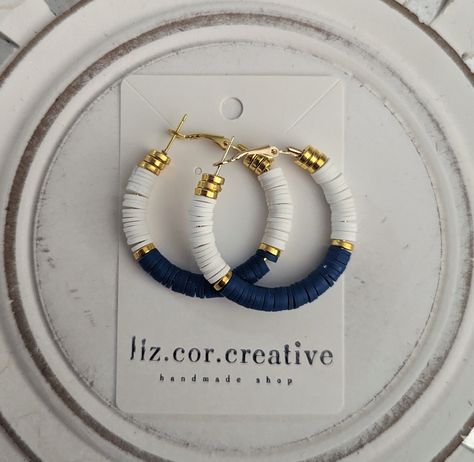 "+ Style name: Navy White and Gold Clay Beaded Hoops + beaded dangle hoop earrings with blue, and white clay heishi beads and gold bead accent + Hoops are 1 1/2\" diameter + gold hoops with lever back closure + available in 2 variations - Navy with White and Gold Pink and Gold + All lizcorcreative hoop earrings will come packaged on a hand-stamped kraft earring card in a clear sealed bag Free Domestic Shipping Follow along Instagram https://www.instagram.com/lizcorcreative/ Facebook https://www. Flat Bead Earrings, Flat Clay Bead Earrings, Polymer Clay Bead Earrings, Heishi Earrings, Clay Bead Earrings Ideas, Nautical Jewelry Diy, Clay Bead Earrings, Simple Bead Earrings, Diy Earrings Dangle