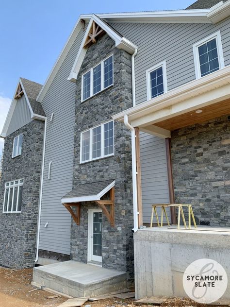 gray stone with wood tone accents Gray Siding House, Grey Siding House, Stone Front House, Grey Siding, Gray House Exterior, Black Wall Lights, Exterior House Color, Floor Trim, Exterior Renovation